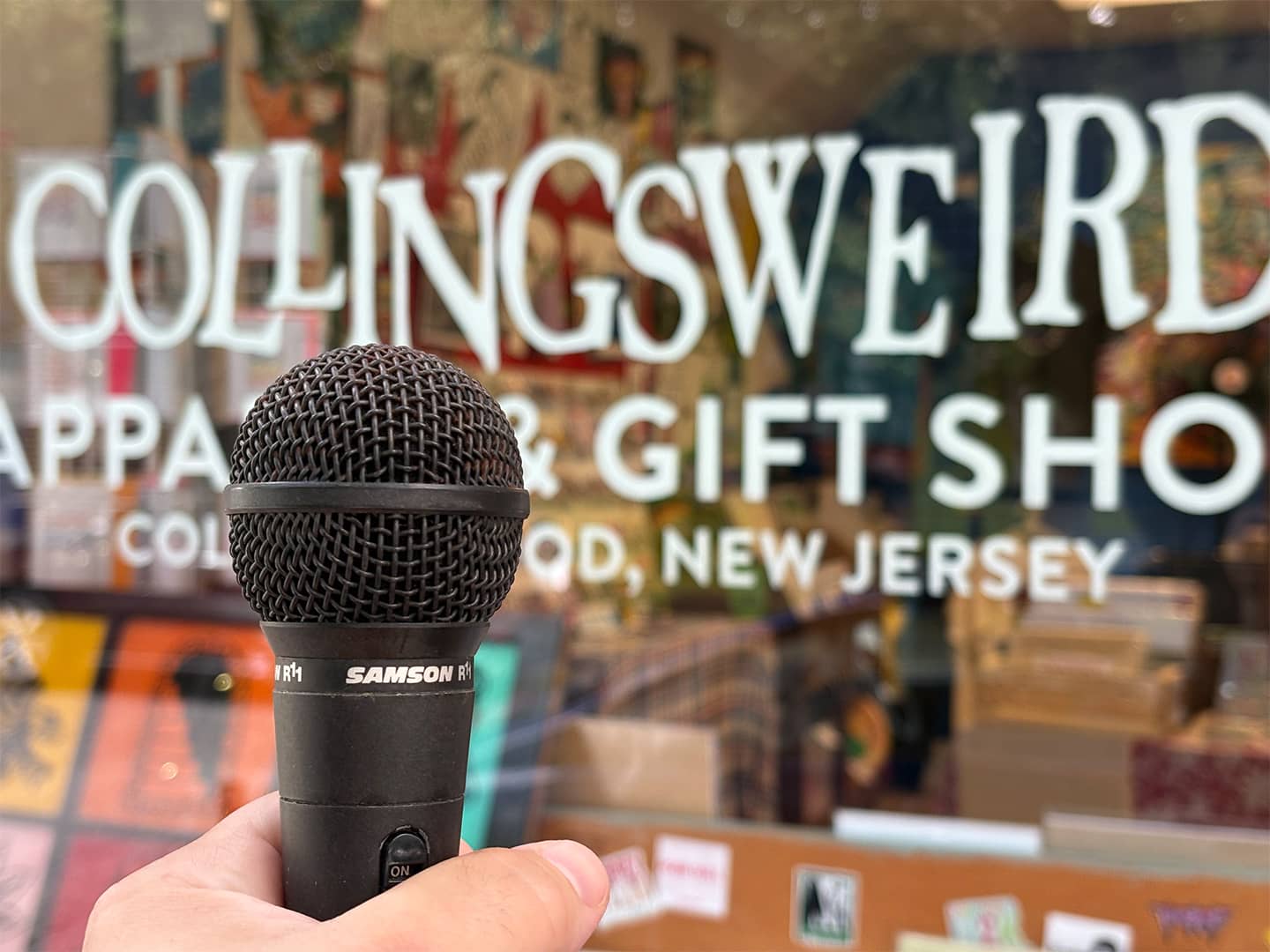 microphone in front of Collingsweird Apparel and Gift Shop